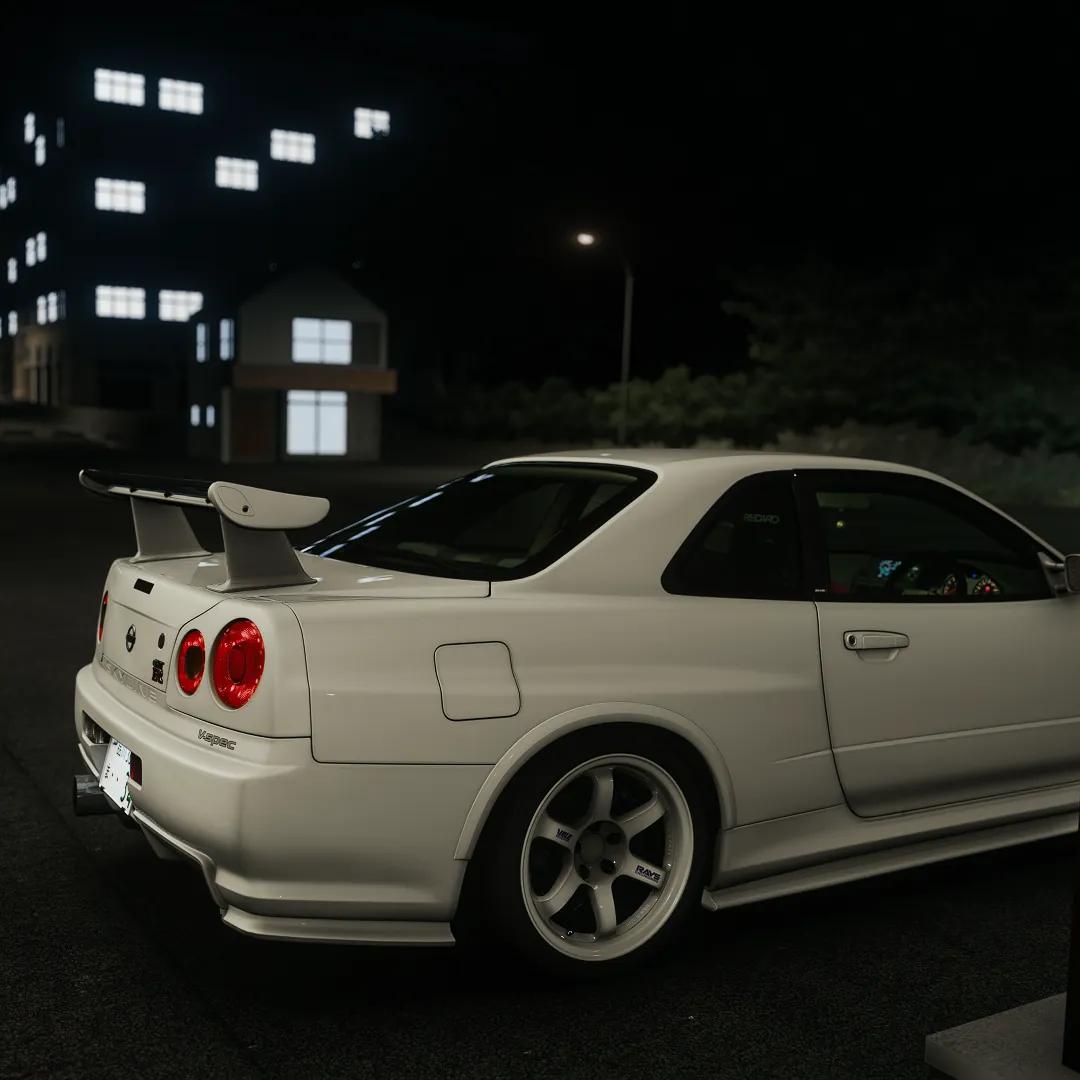 Nissan Skyline R34 at night with city lights on an Assetto Corsa traffic server